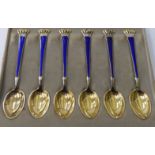 A set of six Danish silver gilt teaspoons with blue enamelled stems and crown finials cased