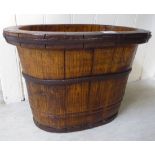 A late 19thC rustically constructed oak and wrought iron bound oval planter 12''h 19''w BSR