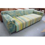 A modern patterned fabric upholstered three person low, level back settee,