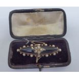 A late Victorian yellow metal mourning brooch, set with an oval onyx tablet,