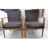 A pair of 'retro' Parker Knoll beech framed and fabric covered armchairs, model no.