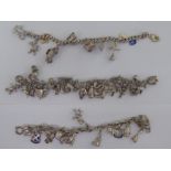 Three similar silver and white metal charm bracelets with various charms 11
