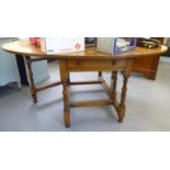 A modern oak dropleaf dining table with an end drawer,