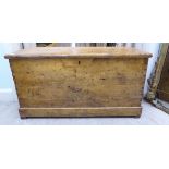 An early 20thC rustically constructed pine chest with straight sides and a hinged lid,
