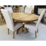 A modern light oak pedestal dining table 29.