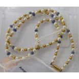A necklet set with seed pearls, gold and glass beads,
