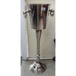 A cast metal freestanding wine cooler with opposing handles 30''h SR