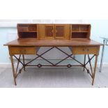 A mid 20thC teak desk, the superstructure with two doors and two pairs of drawers and open shelves,