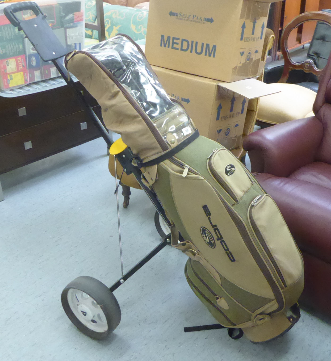 A Cobra golf bag; gentlemens right-handed Dunlop golf clubs; a Dunlop golf trolley;