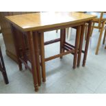 A nesting set of three 1980s teak finished occasional tables,