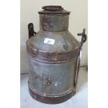 A cast metal milk churn with a swing top handle 17''h BSR