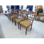 A set of six Edwardian mahogany framed bar and spindled back dining chairs, the sprung seat frames,