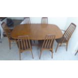 A 1970s teak dining table,