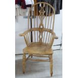 A modern beech and pine framed double splat and spindled back Windsor armchair,