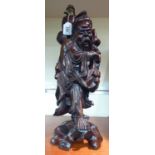 A 20thC carved Chinese lacquered fruitwood figure, converted to a table lamp,