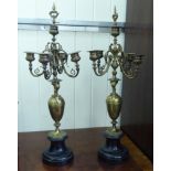 A pair of late Victorian lacquered brass four branch clock sidepieces,
