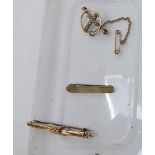 Three items of personal ornament: to include a gold coloured metal 'Baby' pin boxed 11