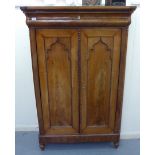 A mid 19thC Continental mahogany cabinet with a frieze drawer and two panelled doors,