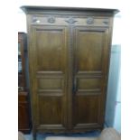 A mid 19thC oak armoire with a moulded cornice, the frieze engraved & dated 1846,