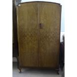 A mid 20thC walnut finished double wardrobe with a pair of doors,