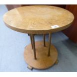 A 1930s Art Deco design, oak occasional table, raised on four gilded pillars,