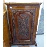 An early/mid 19thC stained oak corner cabinet of slender proportions with a floral carved,