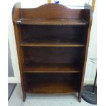 A mid 20thC stained oak open front, three tier bookcase,
