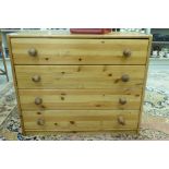 A modern pine four drawer dressing chest,