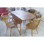 An Ercol beech and elm drop leaf breakfast table, raised on square,
