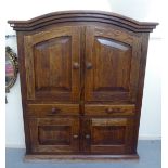 An early 20thC French panelled oak cupboard with a round arched top, over a pair of doors,