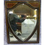 An Edwardian bevelled mirror, the shield shaped plate with two quadrant inserts,