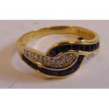 An 18ct gold diamond and sapphire crossover ring
