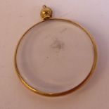 A 9ct gold framed clear plastic set pendant