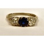 A platinum three stone ring, claw set with a sapphire,