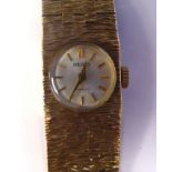 A lady's Seiko 9ct gold wide, bark effect, flexible link bracelet wristwatch,