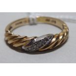 A 9ct gold twist set diamond ring