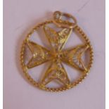 A yellow metal filigreeworked pendant,