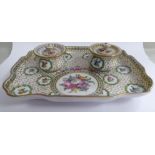 An early 20thC Dresden porcelain dressing table tray with a pair of squat, bulbous covered pots,