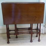 An Edwardian mahogany Sutherland table, raised on slender,