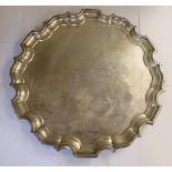 A Georgian style silver salver with a raised piecrust border,