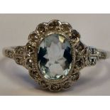 A white gold coloured metal ring, set with an aquamarine,