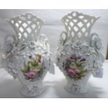 A pair of late 19thC Continental porcelain vases, each with a waisted, latticed neck,