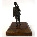 An early 20thC cast and patinated bronze figure,