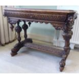 A late Victorian profusely carved oak hall table,