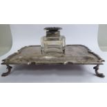 A silver standish, the platform with a shaped, applied wire border,