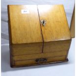 A late Victorian oak desktop stationery cabinet with a double hinged front,