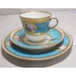 A 19thC porcelain trio, decorated in duck egg blue and gilding with miniature landscape studies,