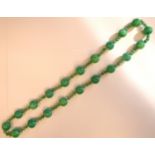 A jade coloured hardstone uniform bead necklace with triple spacers