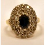 A gold coloured metal sapphire and diamond cluster ring