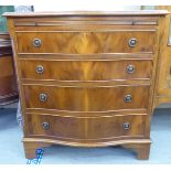 A modern yewwood serpentine front dressing chest with a brushing slide, over four drawers,